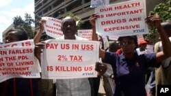 FILE: Teachers hold banners during a protest against the high cost of living, in Zimbabwe's capital Harare on Nov. 9, 2018.