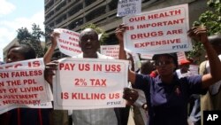 Teachers hold banners during a protest against the high cost of living, in Zimbabwe's capital Harare on Nov. 9, 2018.