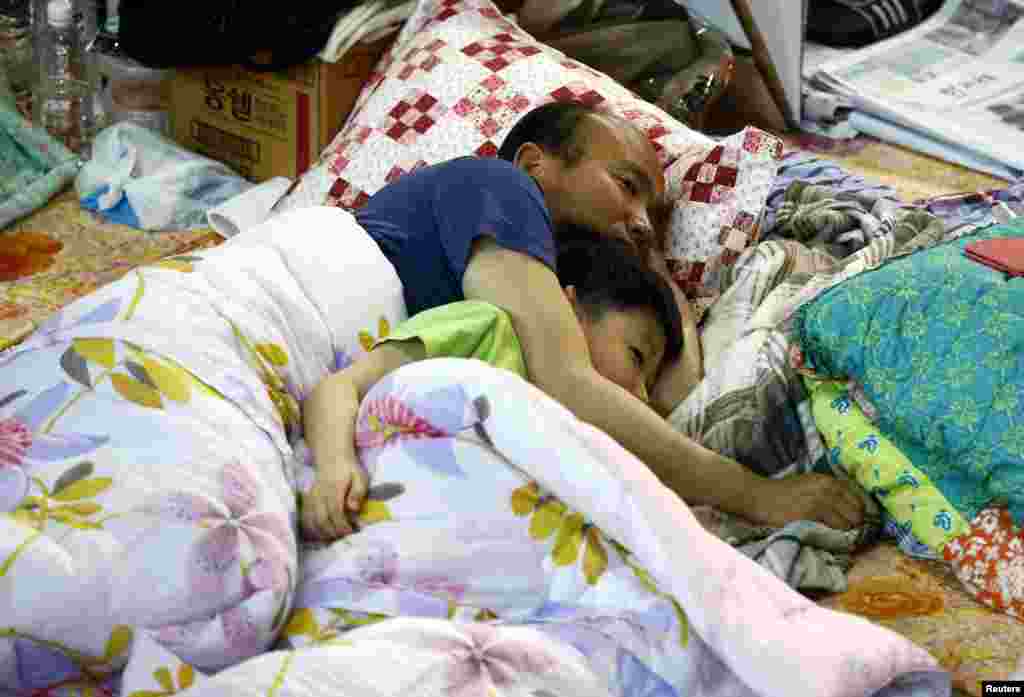 Family members of a missing passenger from the capsized passenger ferry, Sewol, wait for news of the rescue operation at a makeshift accommodation, in the port city of Jindo, April 23, 2014.