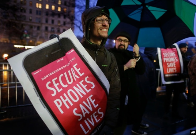 FILE - Protesters demonstrate against a government demand that Apple unlock an iPhone at a rally outside the Apple store on Fifth Avenue in New York, Feb. 23, 2016.