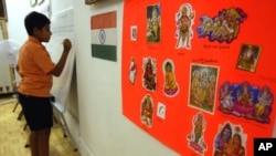 A poster displaying the religions of India and the Indian flag hang on the wall at the India Heritage Camp in 2006. A new study shows Hindus are more educated and earn more than any other religion in the U.S.