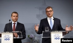 FILE - Finnish Minister of Finance and National Coalition chairman Petteri Orpo (L) and Finnish Prime Minister and Centre Party chairman Juha Sipila attend a news conference at the PM's official residence Kesaranta in Helsinki, Finland, June 12, 2017.