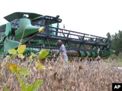 FILE - A farmer checks his combine as he gets ready to harvest his soybean crop at his farm in Turbeville, South Carolina, Oct. 5, 2016.