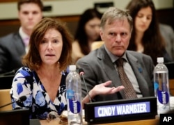 Fred Warmbier, right, listens as Cindy Warmbier speaks of their son Otto Warmbier, an American who died last year, days after his release from captivity in North Korea, May 3, 2018, at the U.N.