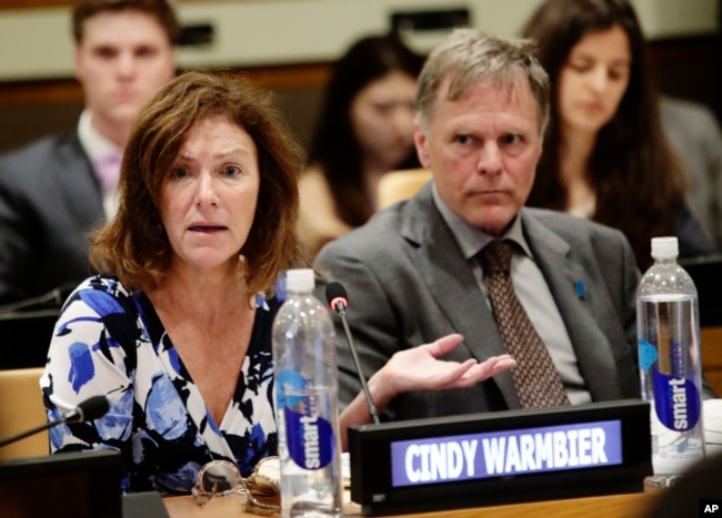 FILE - Fred Warmbier, right, listens as his wife Cindy Warmbier, speaks of their son Otto Warmbier, an American who died last year, days after his release from captivity in North Korea, May 3, 2018, at the U.N.