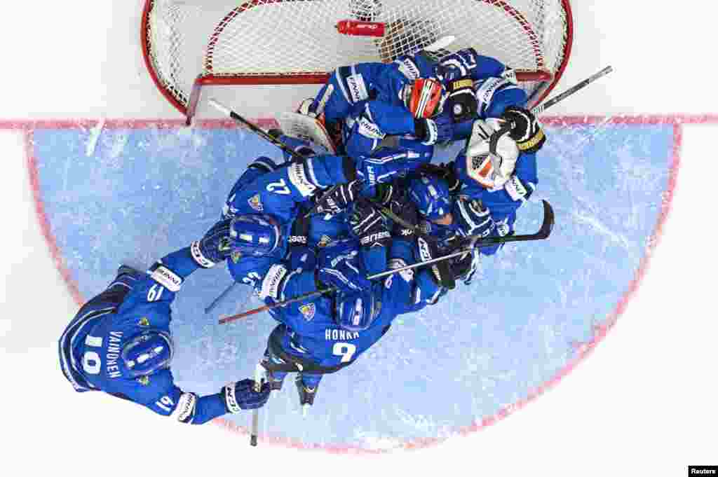 Jubilant Finnish players land in a heap on top of goalie Juuse Saros after a 5-3 victory over Czech Republic in the World Junior Hockey Championships quarter final match at the Malmo Arena in Malmo, Sweden.