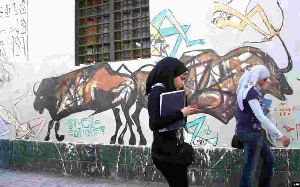 Young women on Mohamed Mahmoud Street, scene of fierce clashes in past months. (VOA Photo - E. Arrott)