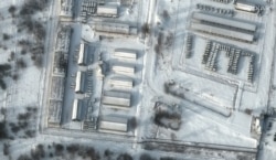 This handout satellite image released by Maxar Technologies shows a close up of armored personnel carriers and trucks at Russia's Klimovo storage facility, in Bryansk Oblast, 13 kilometers north of the Russia/Ukraine border, Jan. 19, 2022.