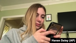 Laurel Foster holds her phone in San Francisco. Foster is among teens involved in Stanford University research testing whether smartphones can be used to help detect depression and potential self-harm. 