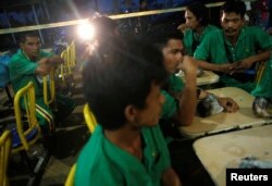 Survivors wait to be interviewed by the police at a temporary holding area after their boat capsized off Batam, in Nongsa, Batam, Indonesia Nov. 2, 2016.