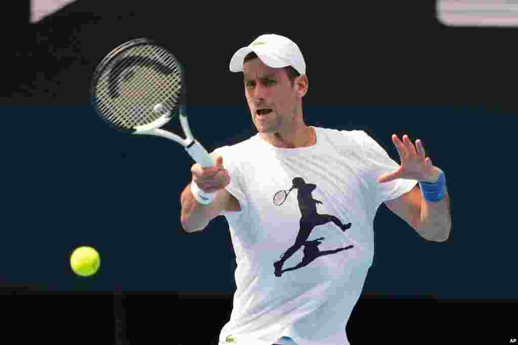 In this photo provided by Tennis Australia, the defending champion Serbia&#39;s Novak Djokovic, practices at the Rod Laver Arena ahead of the Australian Open at Melbourne Park in Melbourne, Australia.