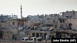 FILE - After Islamic State extremists swept into Kobani in mid-September, Kurdish fighters and U.S.-led airstrikes fought to reclaim it. The Syrian town bears battle scars, as shown Nov. 19, 2014. 