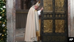 FILE - Pope Francis closes the Holy Door of St. Peter's Basilica at the Vatican, Nov. 20, 2016.