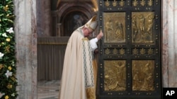 FILE - Pope Francis closes the Holy Door of St. Peter's Basilica at the Vatican.
