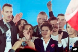 Beata Szydlo, candidate for prime minister of the conservative opposition Law and Justice party in Poland’s general elections Sunday celebrates with supporters at a party convention in Warsaw, Oct. 22, 2015. (AP Photo/Czarek Sokolowski)