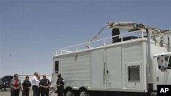 President Barack Obama and Homeland Security Secretary Janet Napolitano examine an x-ray vehicle as they tour the Bridge of America Cargo Facility during their visit to the U.S.-Mexico border in El Paso, Texas, May 10, 2011