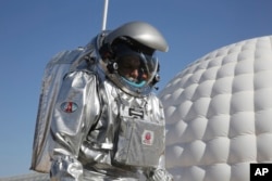 This Feb. 7, 2018, photo shows analog astronaut Kartik Kumar wearing an experimental space suit during a simulation of a future Mars mission in the Dhofar desert of southern Oman.