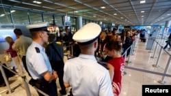 FILE - Police officers are seen patrolling at a security gate inside the main terminal of Frankfurt Airport.