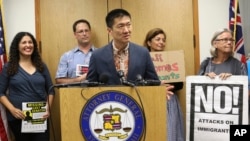 FILE - Hawaii Attorney General Douglas Chin speaks about President Donald Donald Trump's travel ban in Honolulu. A federal judge in Hawaii on Thursday left Trump administration rules in place for a travel ban on citizens from six majority-Muslim countries