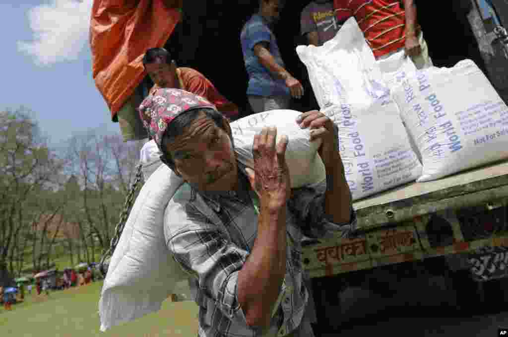 نیپال میں ایک رضاکار کھانے کی اشیاء زلزلہ زدگان تک پہنچا رہا ہے۔