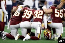 In this file photo Washington Redskins players huddle in the game at AT&T Stadium on December 29, 2019 in Arlington, Texas.