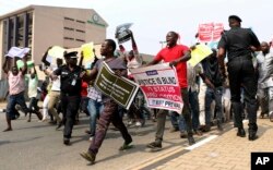 FILE - People protest at the secretariat of the Nigerian Bar Association following the suspension of Nigeria's Chief Justice Walter Onnoghen, in Abuja Nigeria, Jan. 28, 2019.