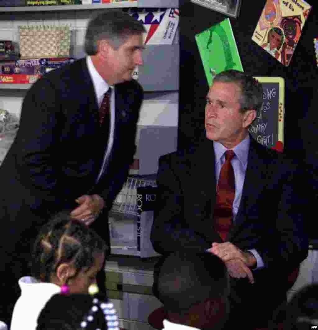 A stunned President George W. Bush looks past Chief of Staff Andrew Card after Card told the President about the planes crashing into the World Trade Center in New York City, during Bush's visit to the Emma E. Booker Elementary School in Sarasota, Fla.,