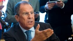 Russian Foreign Minister Sergey Lavrov, gestures while speaking to Organization for Security and Cooperation in Europe (OSCE) Secretary General Lamberto Zannier during their talks in Moscow, Russia, Wednesday, June 11, 2014