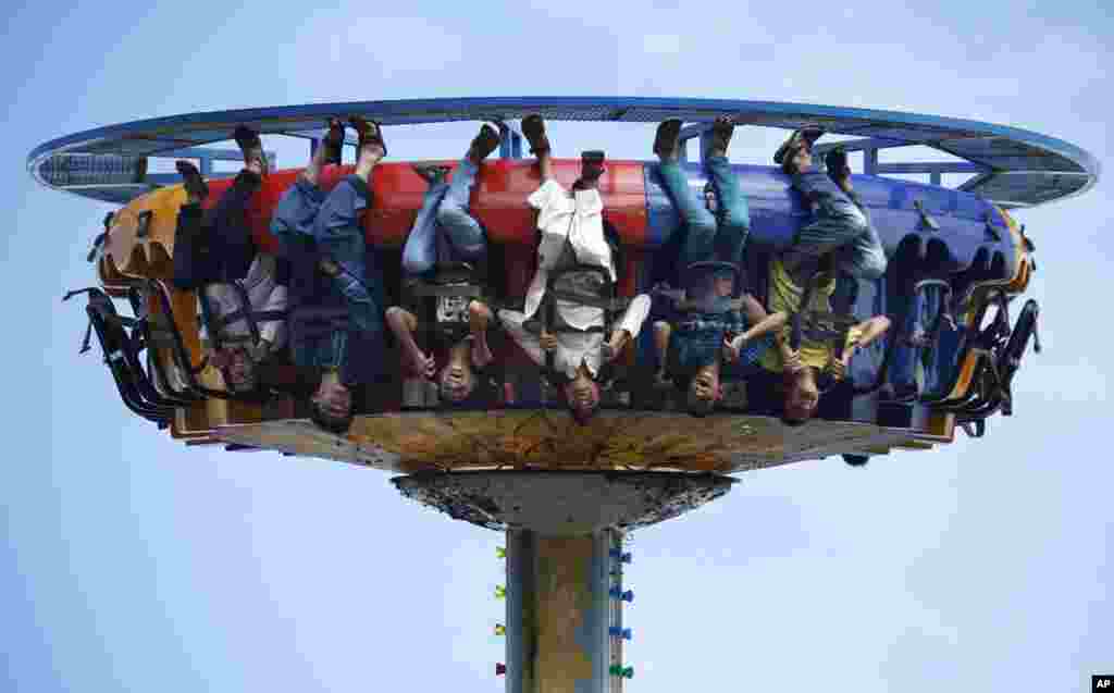 Pakistani youngsters taking a ride at an amusement park in Rawalpindi