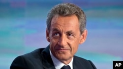 FILE - Former French President Nicolas Sarkozy, poses prior to a TV interviews at French TV station TF1 in Boulogne-Billancourt, outside Paris, Aug. 24, 2016. 