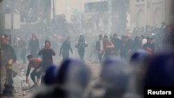 Anti-riot police officers clash with people protesting against President Abdelaziz Bouteflika, in Algiers, Algeria, March 8, 2019. 