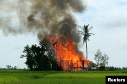 A house is seen on fire in Gawduthar village, Maungdaw township, in the north of Rakhine state, Myanmar, Sept. 7, 2017.