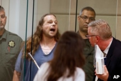 Jeremy Joseph Christian shouts as he is arraigned in Multnomah County Circuit Court in Portland, Ore., May 30, 2017.