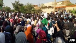 FILE - Sudanese protesters chant slogans during an anti-government demonstration in the capital Khartoum's twin city of Omdurman on Jan. 31, 2019. 