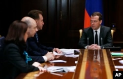 FILE - Russian Prime Minister Dmitry Medvedev chairs a government meeting in the Gorki residence outside Moscow on ways to shore up the plummeting ruble, Dec. 16, 2014.