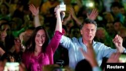 FILE - Mauricio Macri, presidential candidate of the Cambiemos alliance, and Maria Eugenia Vidal, Buenos Aires province governor-elect, appear at a rally in Lanus on the outskirts of Buenos Aires, Oct. 21, 2015.