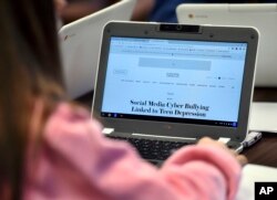FILE - A student in a Connecticut high school searches for information on cyberbullying, Dec. 20, 2017.