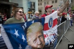 Trump supporters hold a counter rally during "100 Days of Failure" protest and march, Saturday, April 29, 2017, in New York. Thousands of people across the U.S. are marching on President Donald Trump's hundredth day in office to demand action on climate change.