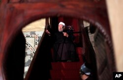 FILE - Shiekh Youssef al-Qaradawi, gives a sermon during Friday prayers at al-Azhar mosque in Cairo, Egypt.