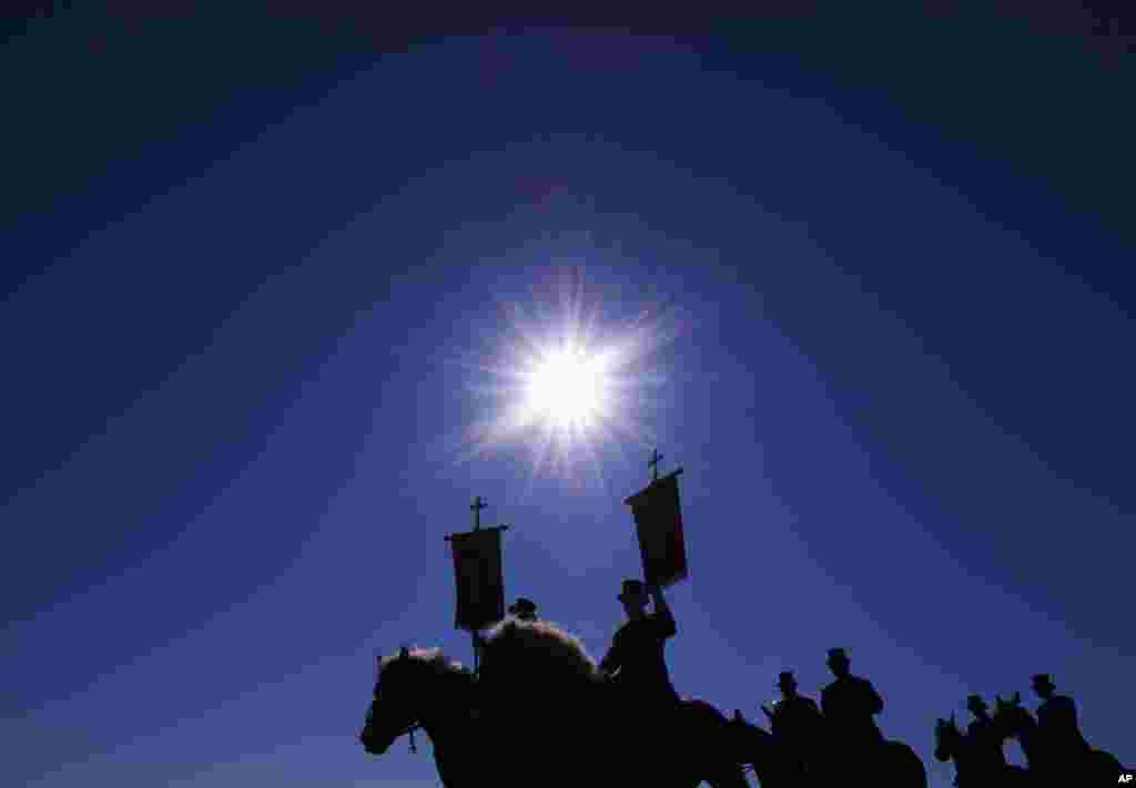 Men carry banners of their parish during the beginning of the Easter riders procession near Ralbitz, eastern Germany.