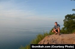 Mikah Meyer enjoys the view of Lake Michigan from Sleeping Bear Dunes National Lakeshore before heading north along the lakeshore.