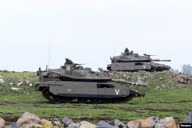 FILE - Israeli soldiers take part in an exercise in the Israeli-occupied Golan Heights, near the cease-fire line between Israel and Syria, March 20, 2017.