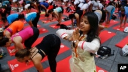 Deepika Agarwal, of Jaipur, India, practices yoga during the 13th annual Solstice in Times Square event, June 21, 2015, in New York.