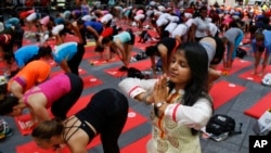 Deepika Agarwal, of Jaipur, India, practices yoga during the 13th annual Solstice in Times Square event, June 21, 2015, in New York.