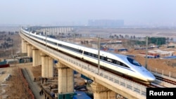 FILE - A high-speed train travelling to Guangzhou is seen running on Yongdinghe Bridge in Beijing.