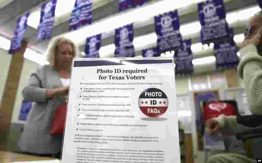 A sign tells voters of voter ID requirements before participating in the primary election at Sherrod Elementary school in Arlington, Texas, March 1, 2016. 