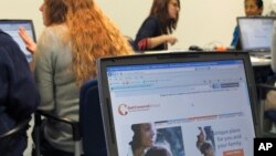 Public health office staff members in Champaign, Illinois, work with people trying to sign up for health care coverage through the Affordable Care Act, also known as Obamacare, October 1, 2013.