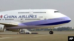 FILE - A China Airlines Boeing 747-400 sits on the tarmac at the Chiang Kai-shek International Airport in Taoyuan, Taiwan.
