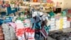 Two elderly women shop for mealie meal and other basic commodities, March 14 2019, in the Mutoko rural area of Zimbabwe. Eastern Zimbabwe receives help to fight drought induced hunger. 