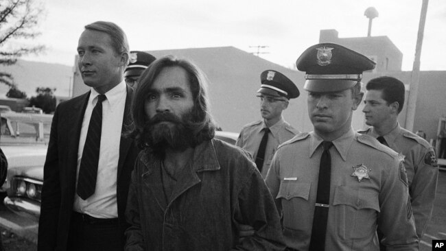 FILE - Charles M. Manson, leader of a hippie cult accused of multiple murders, leaves a Los Angeles courtroom, Dec. 22, 1969.